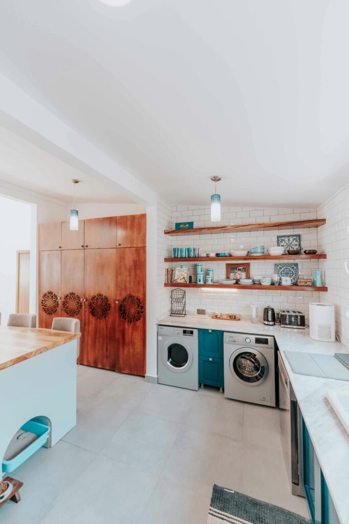 Bright and spacious modern kitchen featuring Scandinavian design elements with wooden and white accents.